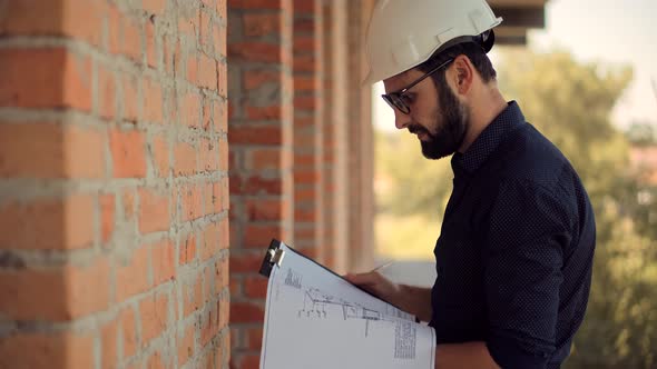 Specialist Builder Construction Architect Inspecting Renovation Object. Builder Foreman On Jobsite.