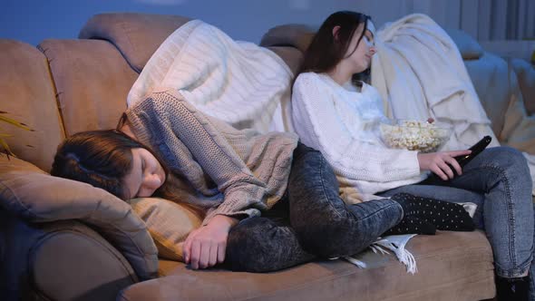 Young Friends Fell Asleep on Sofa While Watching TV Show in Living Room