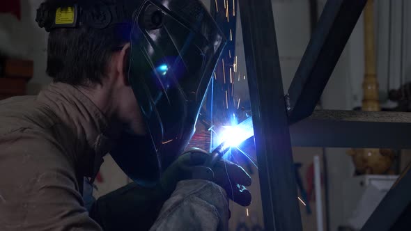 Masked Welder Works With Metal 