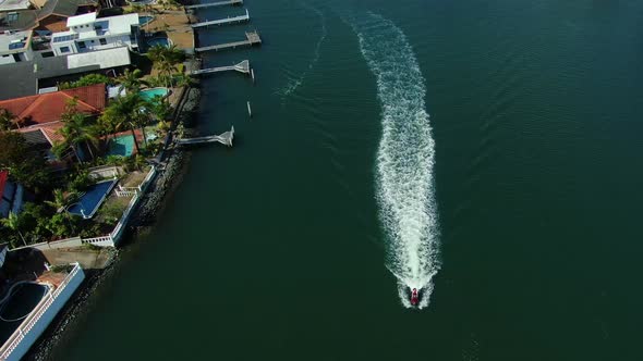 Jet Ski rider cruising up beautiful Gold Coast canal at Surfers Paradise Australia