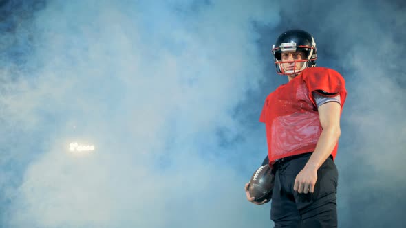 Stadium Covered with Smoke and a American Football Athlete Standing on It