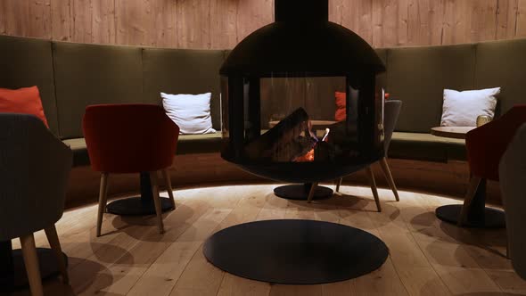 Cosy Fireplace in a Mountain Chalet's Warm Wooden Interior in a Luxury Hotel