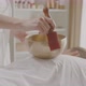 Masseuse Twists Stick Around Singing Bowl During Sound Therapy Session Spa - VideoHive Item for Sale