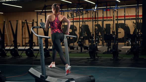 Woman athlete athlete is engaged in cardio training on the treadmill, thin beautiful sports girl