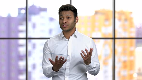 Young Man Giving Business Presentation with Glass Tablet Mockup