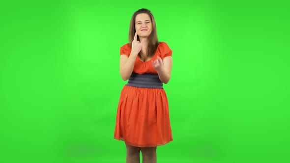 Cute Girl Making a Rock Gesture, Enjoying Life and Laughing. Green Screen