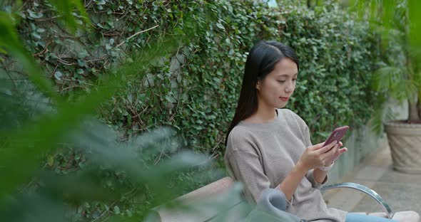 Woman check on smart phone in city