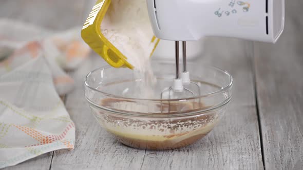 Cook Add Flour To Glass Bowl with Dough. Mixing Dough in Bowl with Motor Mixer.
