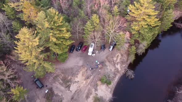 People On Overland Camping Adventure By The River Of Meskugon With Vehicles On Remote Forest Of Leot