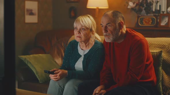 Aged Couple Watching Thriller at Home