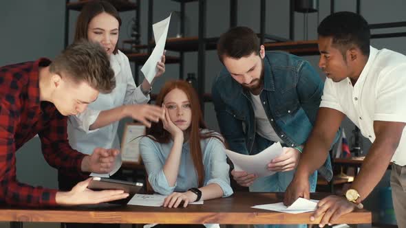 Portrait of Exhausted Young Business Woman Sitting at Table, Multi-ethnic Colleagues Shaking