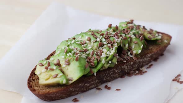 Healthy Avocado Toast Rotating on Wooden Board