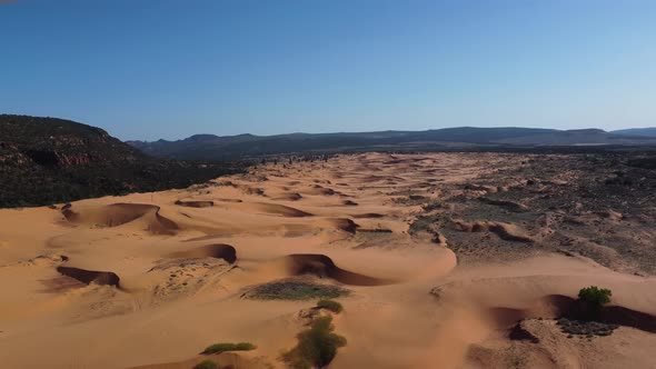 Drone shot panning across Pink Coral Sand Dunes State Park in a generic desert landscape