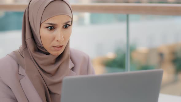 Closeup Young Muslim Woman User Looks Attentively Into Laptop Surprised Arab Businesswoman in Hijab