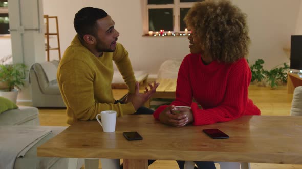 Millennial adult friends socialising together at home