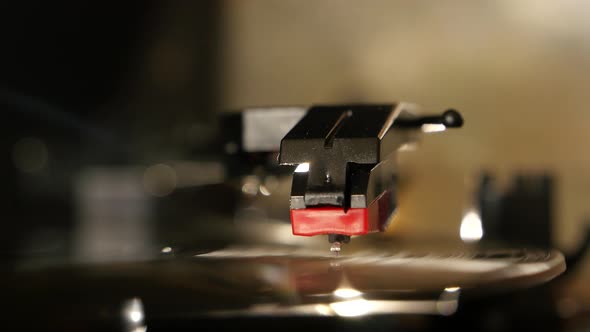 Turntable vinyl record player, man puts a vinyl record and includes a gramophone