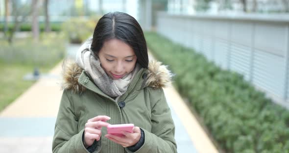 Woman use of mobile phone in outdoor park