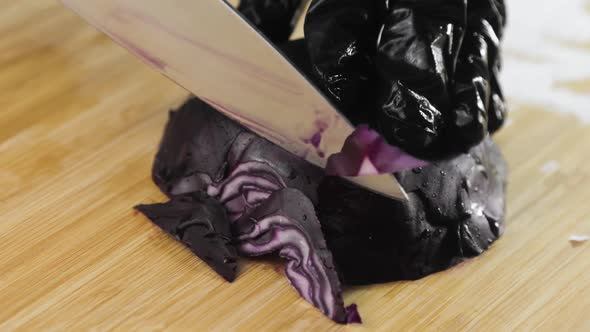 Chef Is Cooking Cutting Fresh Red Cabbage on Wooden Board Hands Closeup