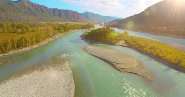 Low Altitude Flight Over Fresh Fast Mountain River with Rocks at Sunny Summer Morning.