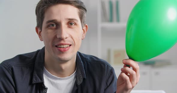 Closeup Emotional Human Male Face Indoors Portrait Caucasian Man Looking at Camera Holding Green Big