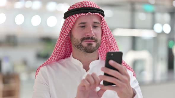 Arab Businessman Using Smartphone, Browsing Internet