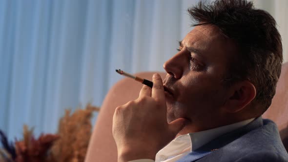 Smoking man, thoughtful.