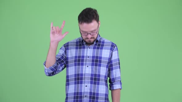 Happy Young Bearded Hipster Man with Rock Hand Gesture