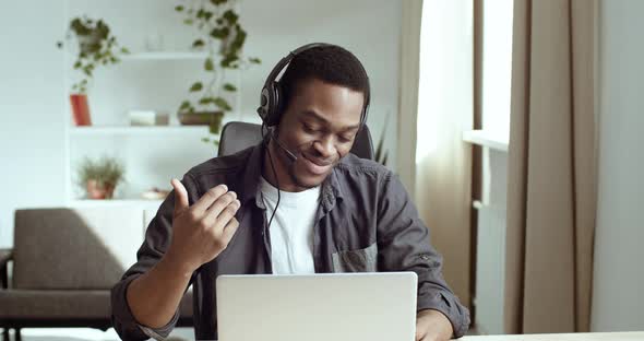 Portrait of Afro American Man in Headphones Talking on Video Chat Conference Online Communicating