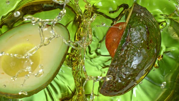 Super Slow Motion Shot of Fresh Avocado Falling and Splashing Into Oil at 1000 Fps