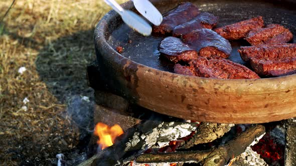 Making Sausage Inan Old Pot On Wooden Fire 1