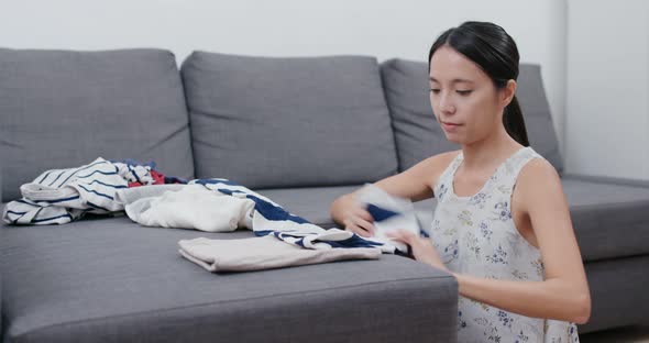 Housewife Folding Clothes at Home