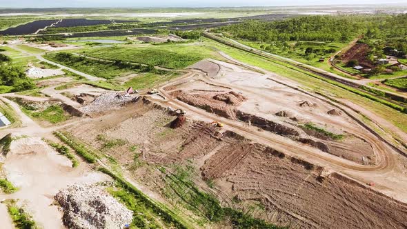 Drone flying towards landfill site as camera slowly tilts down. Location Townsville, Australia.