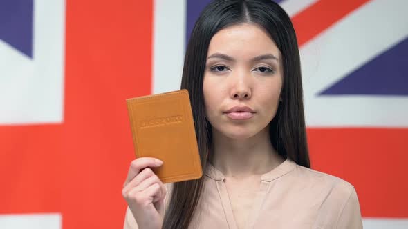 Serious Woman Showing Passport, Great Britain Flag, Business Trip to England