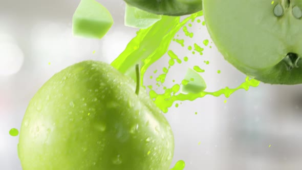 Green Apple with Slices Falling on Kitchen Background