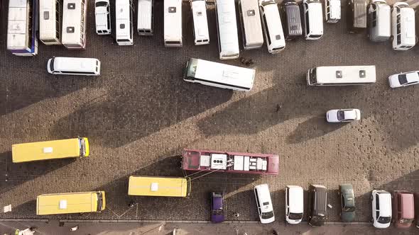 Aerial footage of many cars and buses moving on a busy city street.