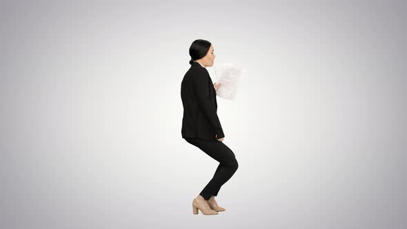 Excited Business Woman Dancing with a Bunch of Papers in Her Hand on Gradient Background