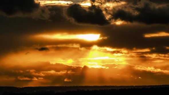 Dramatic Sunset in the Sky Through Orange Layered Cumulus Clouds Timelapse