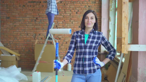 Portrait of a Couple Man and Woman Make Repairs in the House