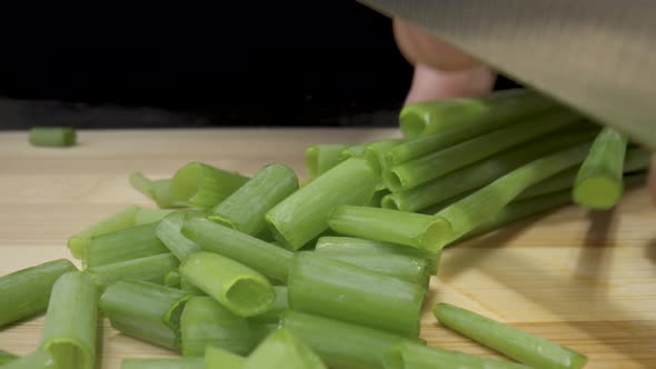 Green Onion are Cut with Knife in Kitchen
