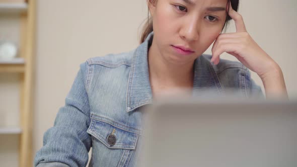 young asian woman sleepy exhausted working at office desk at home office Enjoying time at home.