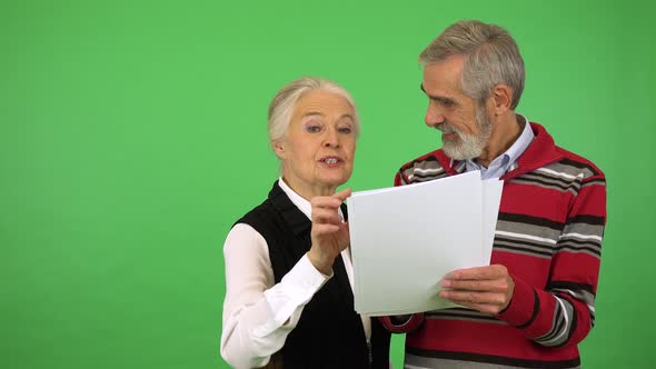 An Elderly Couple Reads a Bunch of Papers, Happy - Green Screen Studio