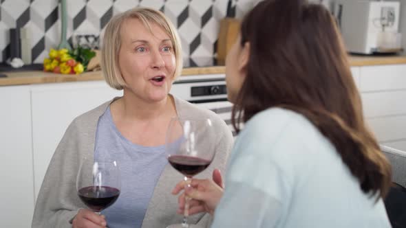 Handheld video of two generation women talking and drinking wine. Shot with RED helium camera in 8K.