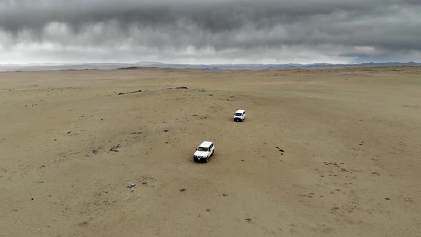 4X4 Suv and Minibus Vehicles of Tourists Doing Safari in Vast Desert