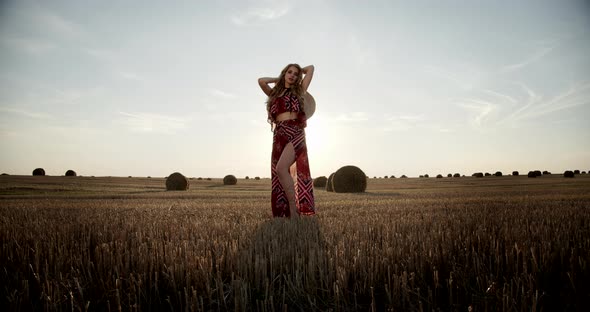 Young Girl In A Field In A Straw Hat