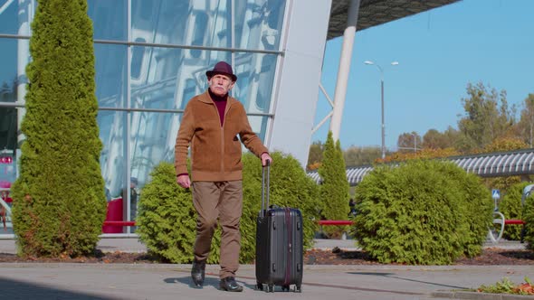 Retired Grandfather Businessman Walking with Luggage Suitcase Bag to Airport Hall or Railway Station