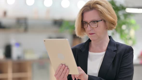 Portrait of Old Businesswoman Using Digital Tablet