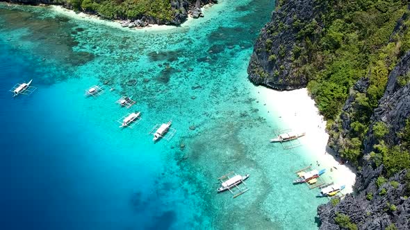 Aerial of turquoise blue sea and white beach of Shimizu island, El Nido, Palawan, Philippines