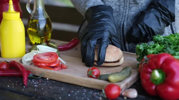 Making Burger  Woman Holding Two Grilled Halves of Burger Bun