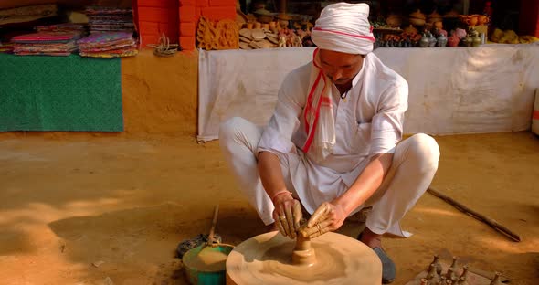 Indian Potter at Work: Throwing the Potter's Wheel and Shaping Ceramic Vessel and Clay Ware: Pot