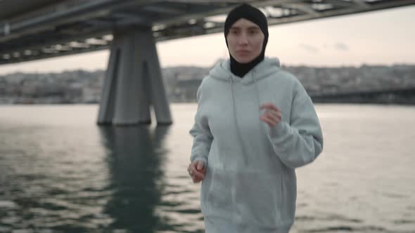 Muslim Female Athlete in Hijab Jogging on City Street